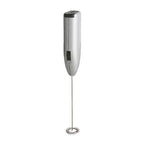 Close-up of the electric milk frother creating creamy foam in a mug.
