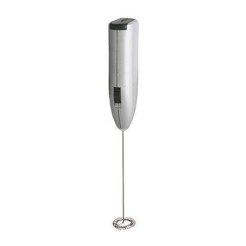 Close-up of the electric milk frother creating creamy foam in a mug.