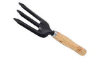 The three essential gardening tools, a garden fork, hand cultivator, and trowel, laid out for display.