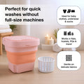 Portable washing machine in its compact, unfolded state, ready for use.