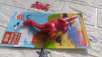 A single red dinosaur-shaped eraser showcasing its detailed design.