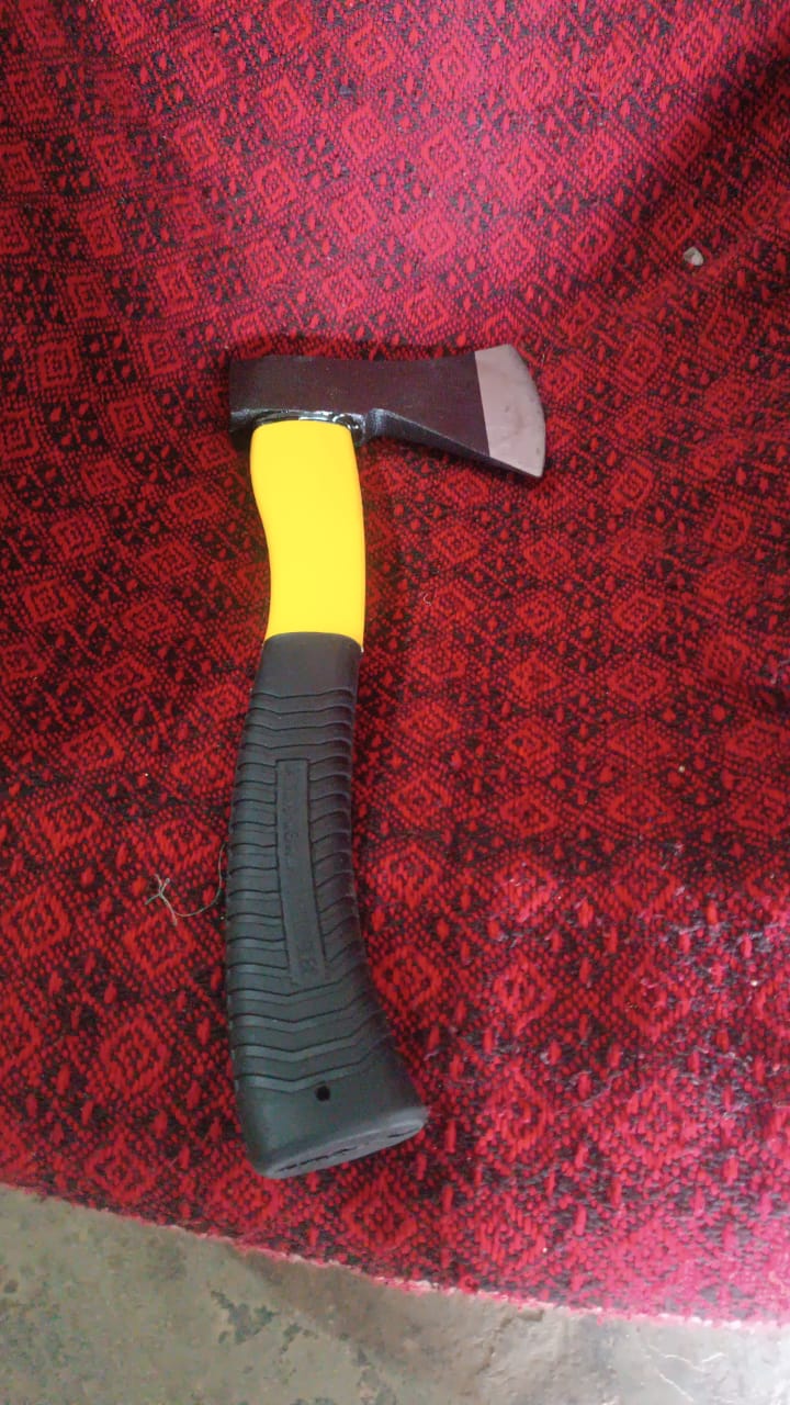 Hatchet axe demonstrating its use for clearing brush in a garden setting.