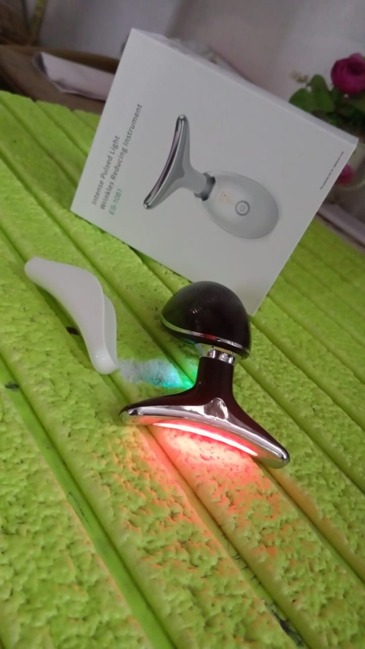 Woman applying the Neck Face Massager to her jawline for a lifting effect.