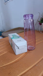 Vertical view of Own Hydrate glass water bottle with BPA-free plastic cap