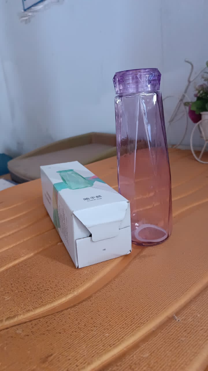 Vertical view of Own Hydrate glass water bottle with BPA-free plastic cap