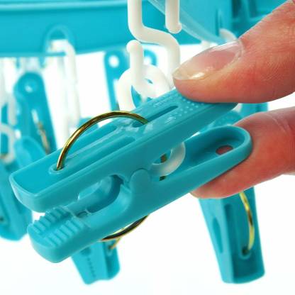 A multicolour 18-clip round plastic cloth drying hanger in use.