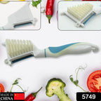 Close-up of the 5-in-1 peeler brush demonstrating its integrated cleaning bristles.