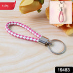 Close-up view of braided two-tone leather-style keychain with metal ring