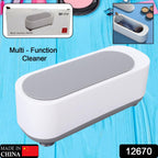 Ultrasonic jewellery cleaner actively cleaning a watch and several rings.