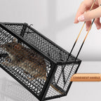 A trapped mouse visible inside the live catch cage, demonstrating humane capture.