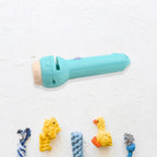 A child's hands playfully hold the compact Mini Projector Torch, ready for projecting images.