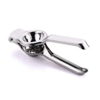 Stainless steel lemon squeezer extracting juice from a sliced lemon.