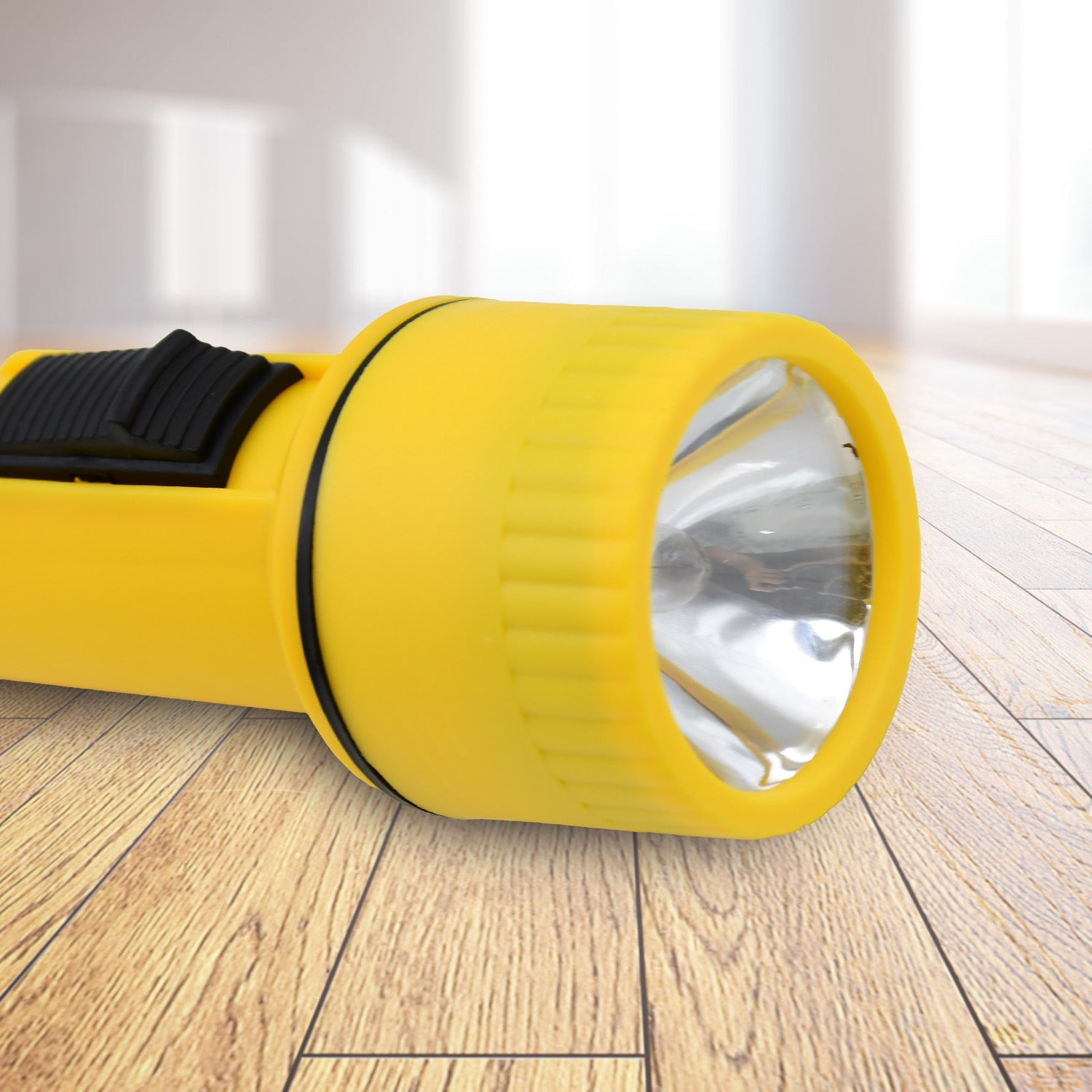 Close-up of a battery-operated LED flashlight showing its power button.