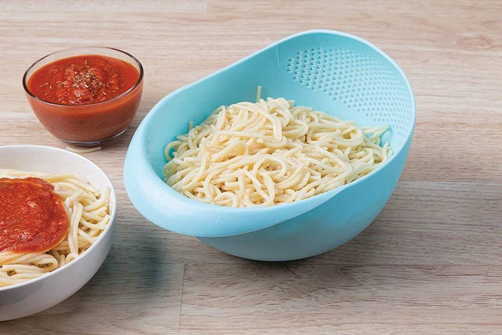 Large plastic rice bowl strainer in use, showing grains being washed.