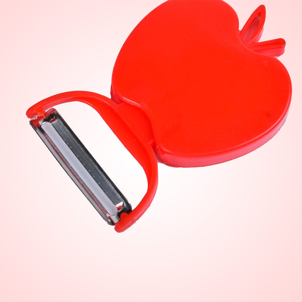 A hand using the folding vegetable peeler to effortlessly peel a potato.