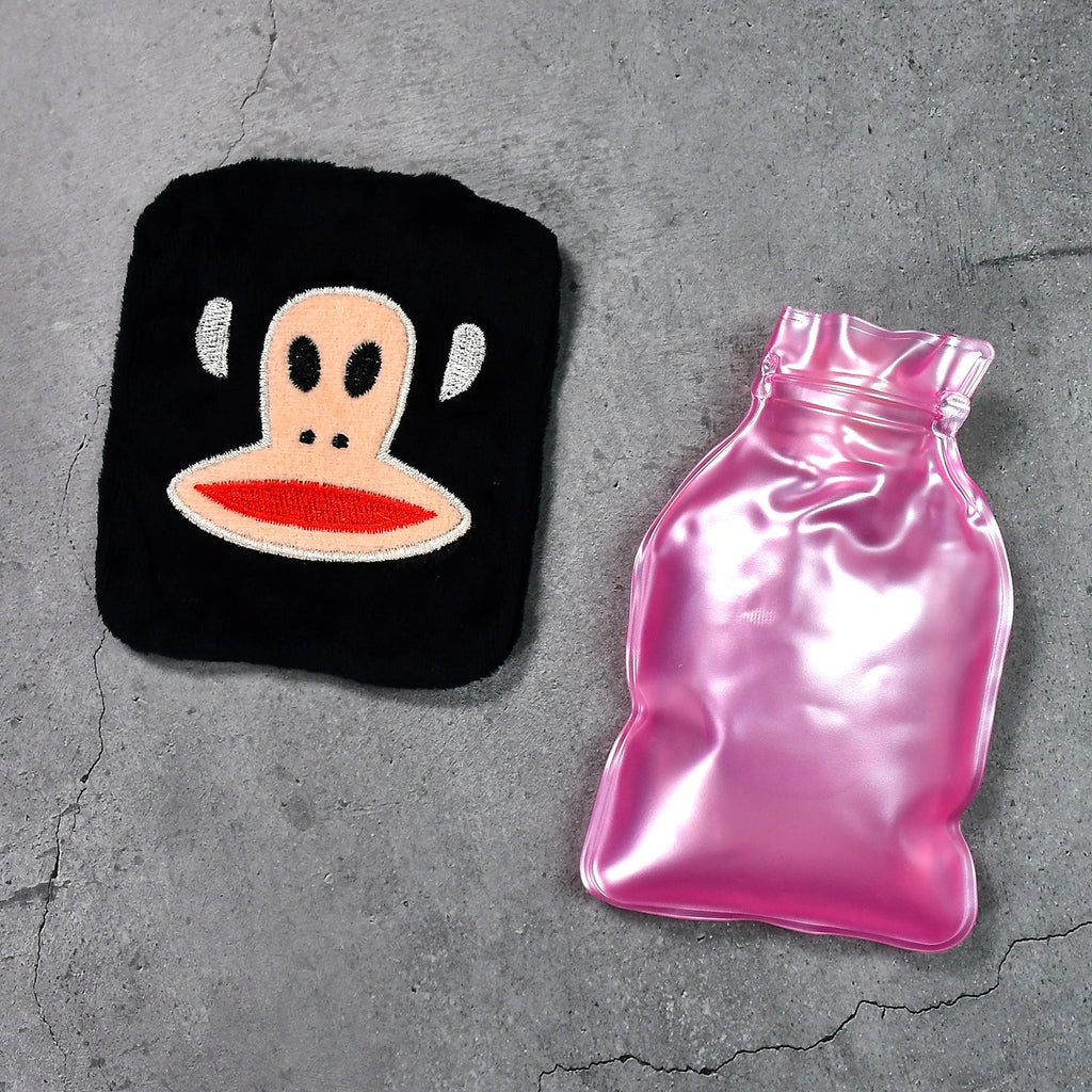 A person using the mini hot water bag on their neck for soothing pain relief.
