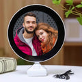 LED Magic Mirror Photo Frame glowing with a picture inside, on a white table.