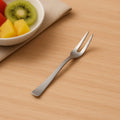 Close-up of a rust-resistant mini fruit fork from the dessert set