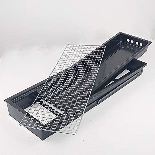 The compact charcoal cooker positioned on a picnic table, ready for grilling.