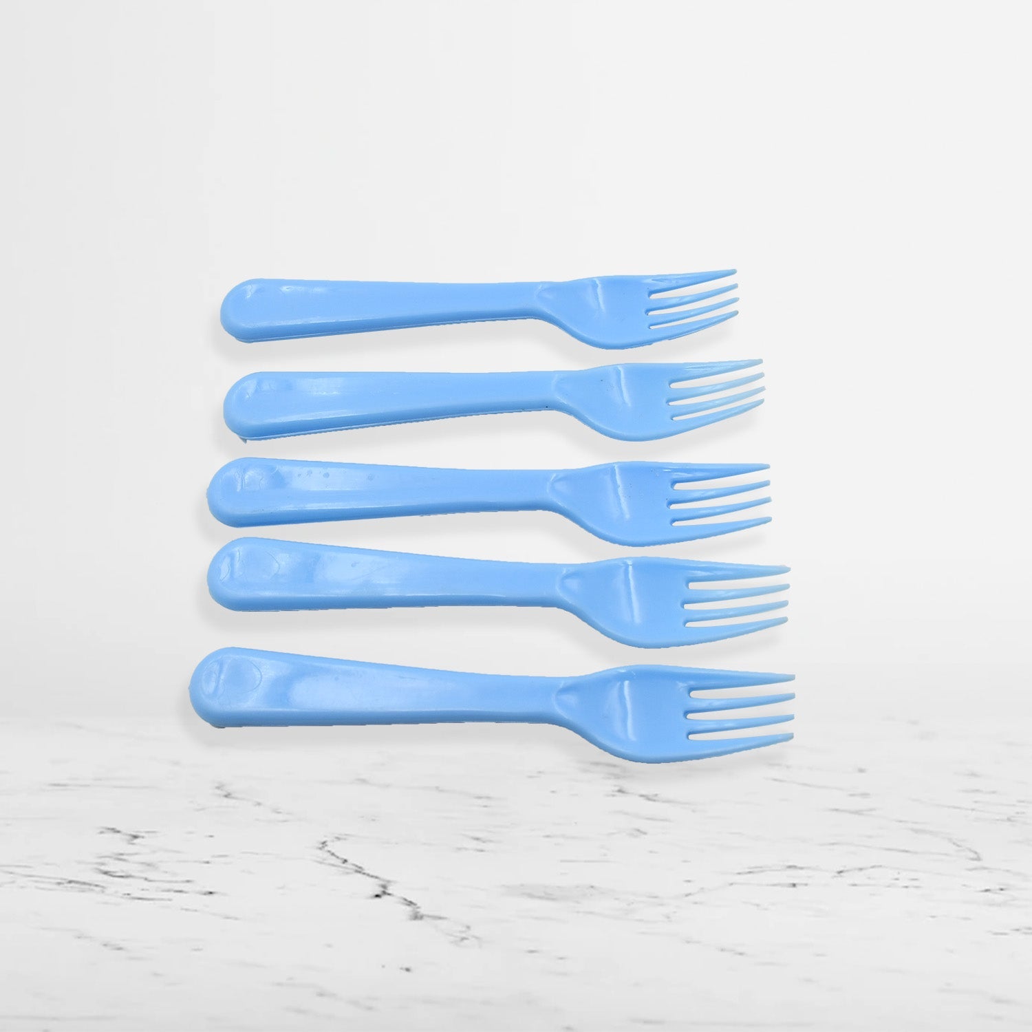 A close-up of the tines of a reusable plastic fork, showing its sturdy construction.