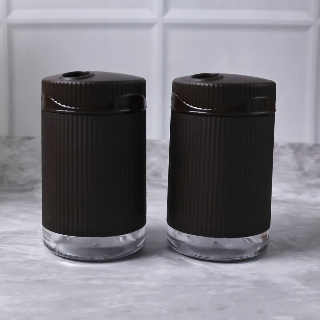 Salt and pepper dispenser set featuring transparent bases for easy spice monitoring