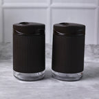 Salt and pepper dispenser set featuring transparent bases for easy spice monitoring