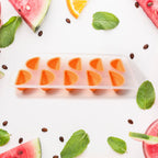 Assortment of colorful fruit-shaped ice cubes in the tray.