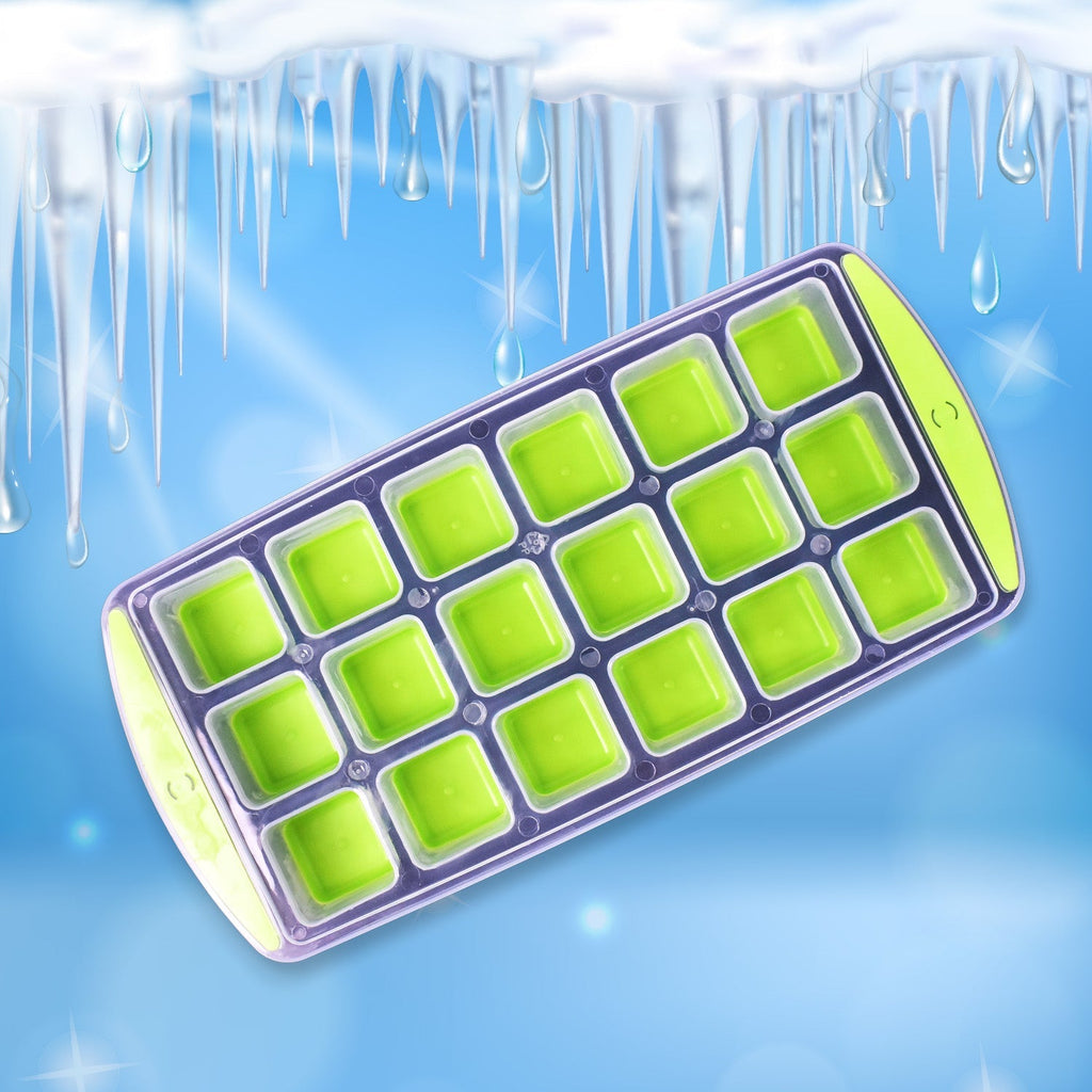 A hand filling the 18-cavity silicone ice cube tray with water, preparing it for freezing.