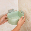 Self adhesive corner shelf installed in a modern bathroom.