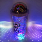 A child's hand holding a vibrant sipper bottle with an LED glow.