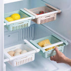 Adjustable fridge organizer drawers pulled out, showing ample storage space.