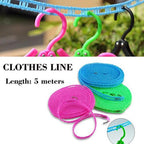 Compactly folded nylon clothesline with hooks, ready for travel or storage.