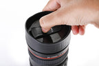 Ergonomic camera lens mug with a comfortable ribbed grip, ready for your drink.