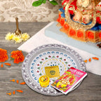 Close-up view of the intricate detailing on the silver plated pooja thali.