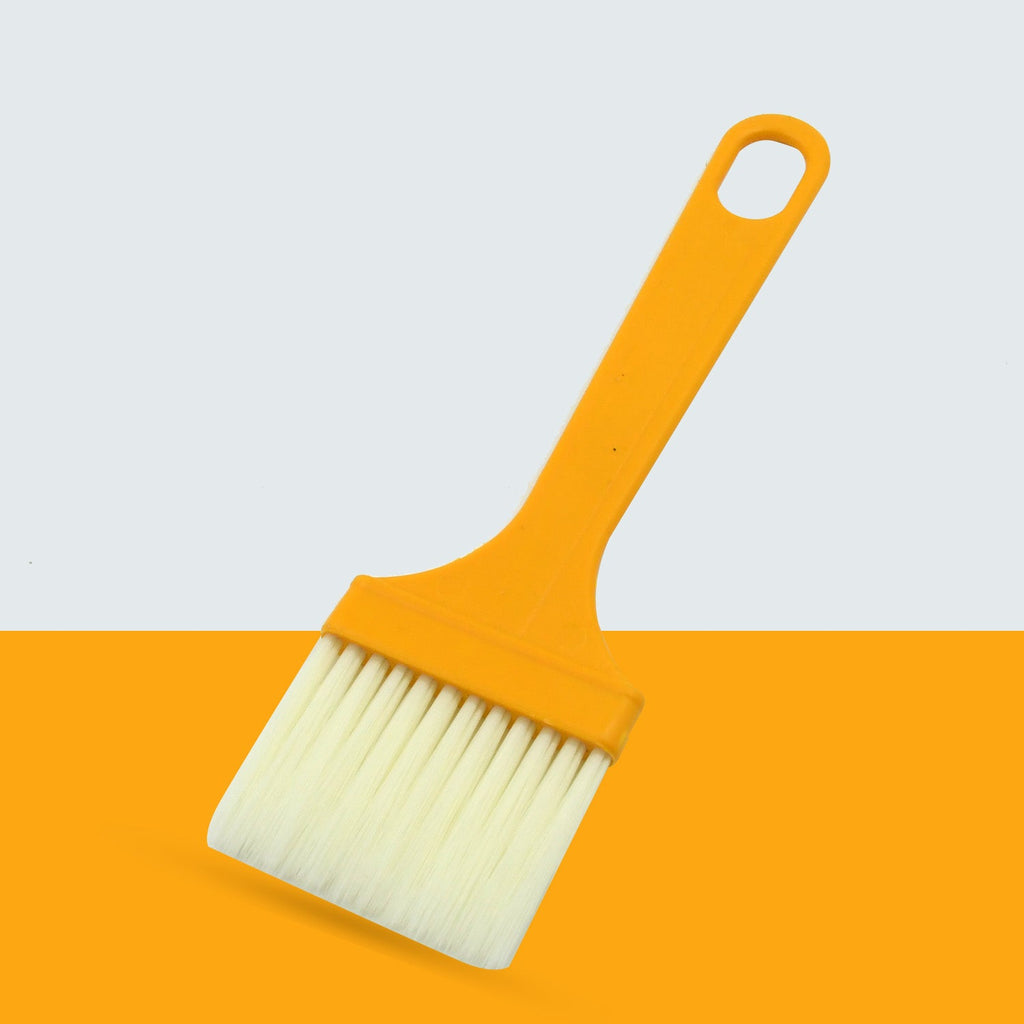Silicone basting brush evenly spreading marinade on food.