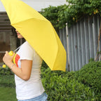 Stylish mini foldable umbrella in its compact banana case.