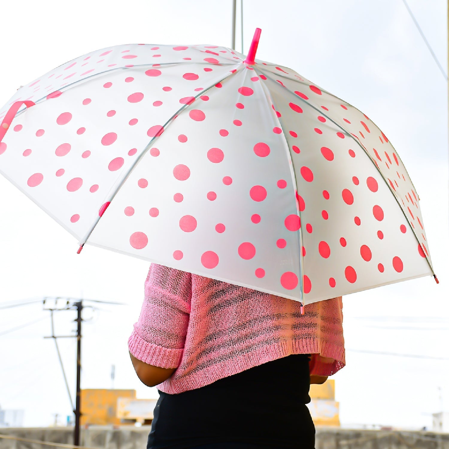 Durable dot printed umbrella with sturdy handle, suitable for men and women.