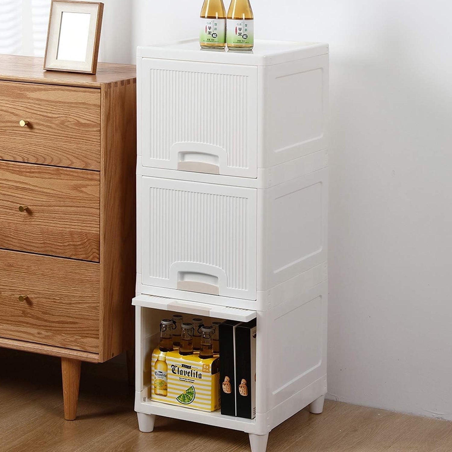 A drawer of the plastic storage cabinet open, revealing generous space for organization.