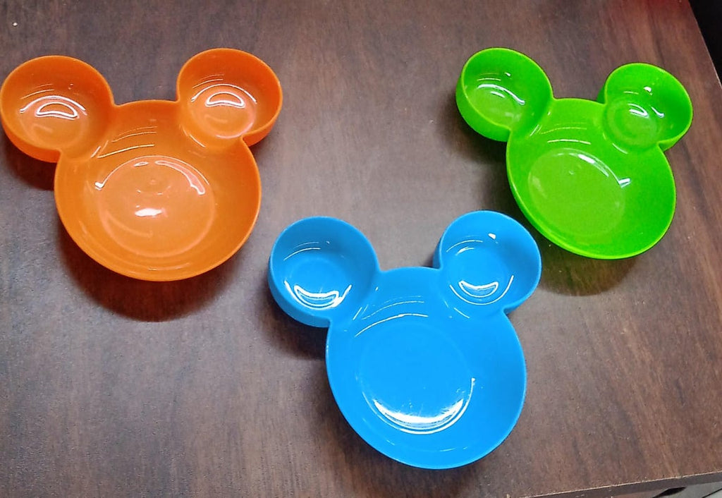 A red Mickey Mouse Kids Plate filled with various child-friendly food items, ready for mealtime.