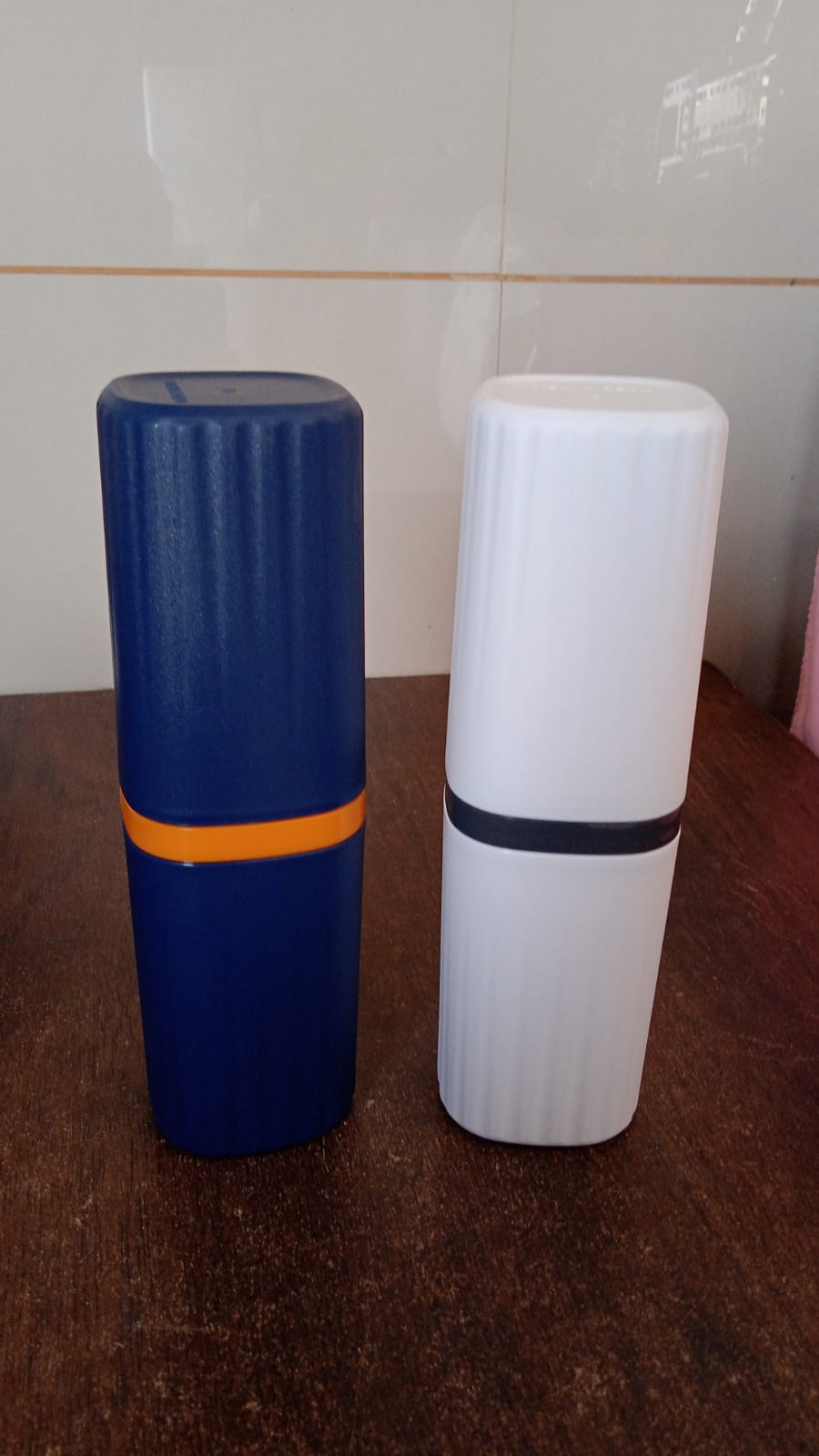 Portable travel toothbrush and toothpaste case neatly packed inside a travel bag.