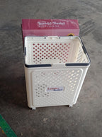 Foldable laundry basket being used to carry laundry with wheels