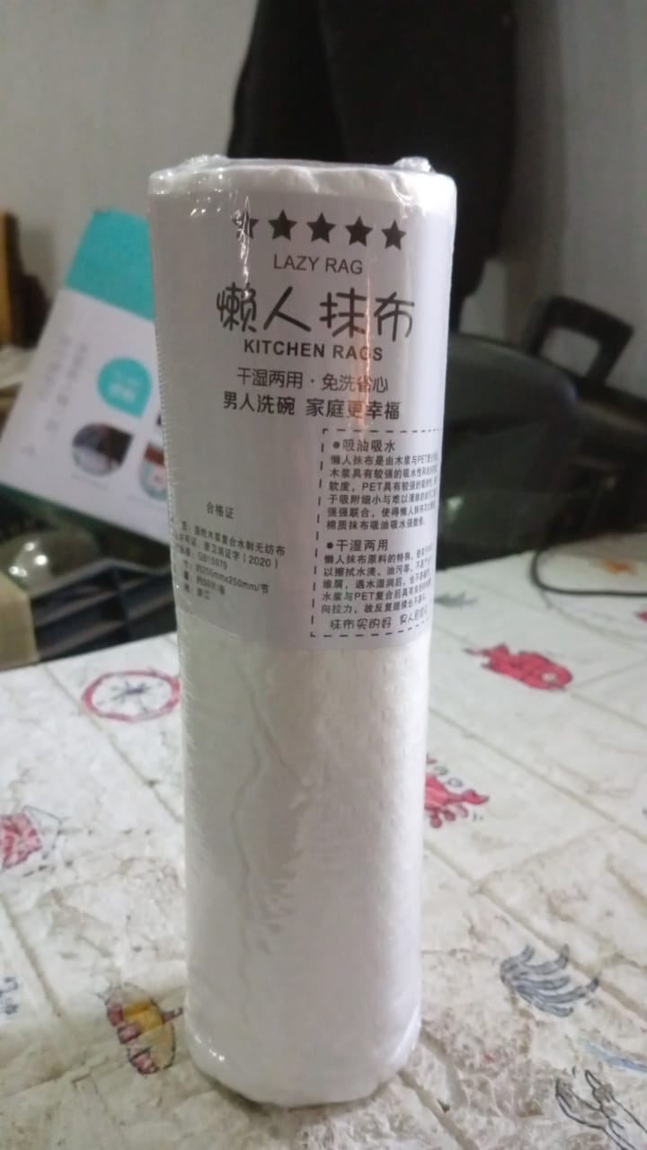 Durable kitchen tissue sheet being used to clean a car surface.