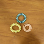 Lifestyle image of colorful spiral hair bands in use
