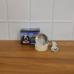 Multicolor crystal ball night light glowing on wooden base