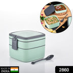 Side view of the green stackable lunch box with a spoon.