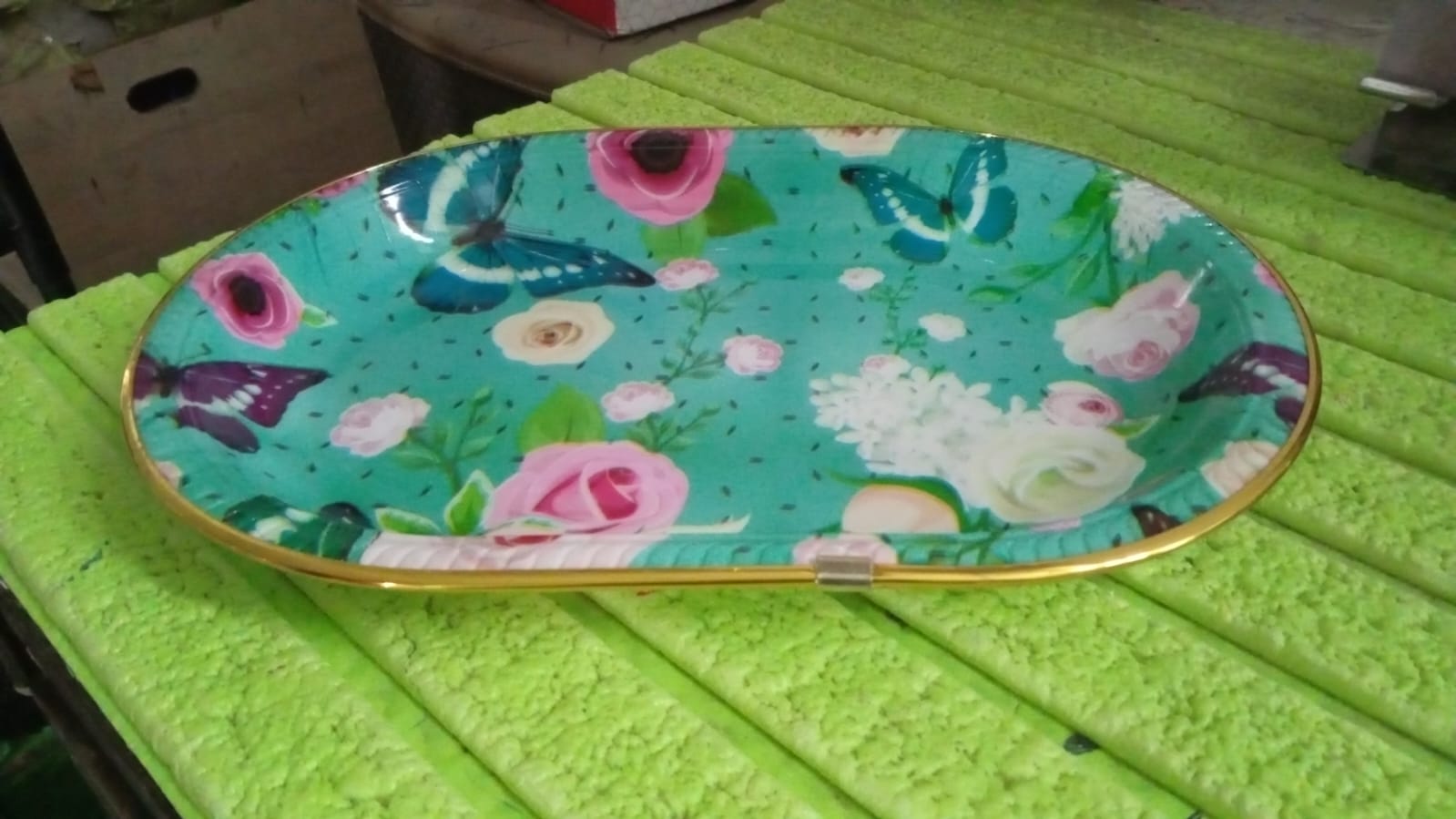 Hand holding the lightweight plastic serving tray, showing ease of use.