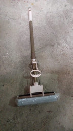 The sponge mop effectively cleaning a tiled floor, demonstrating its dirt removal capabilities.