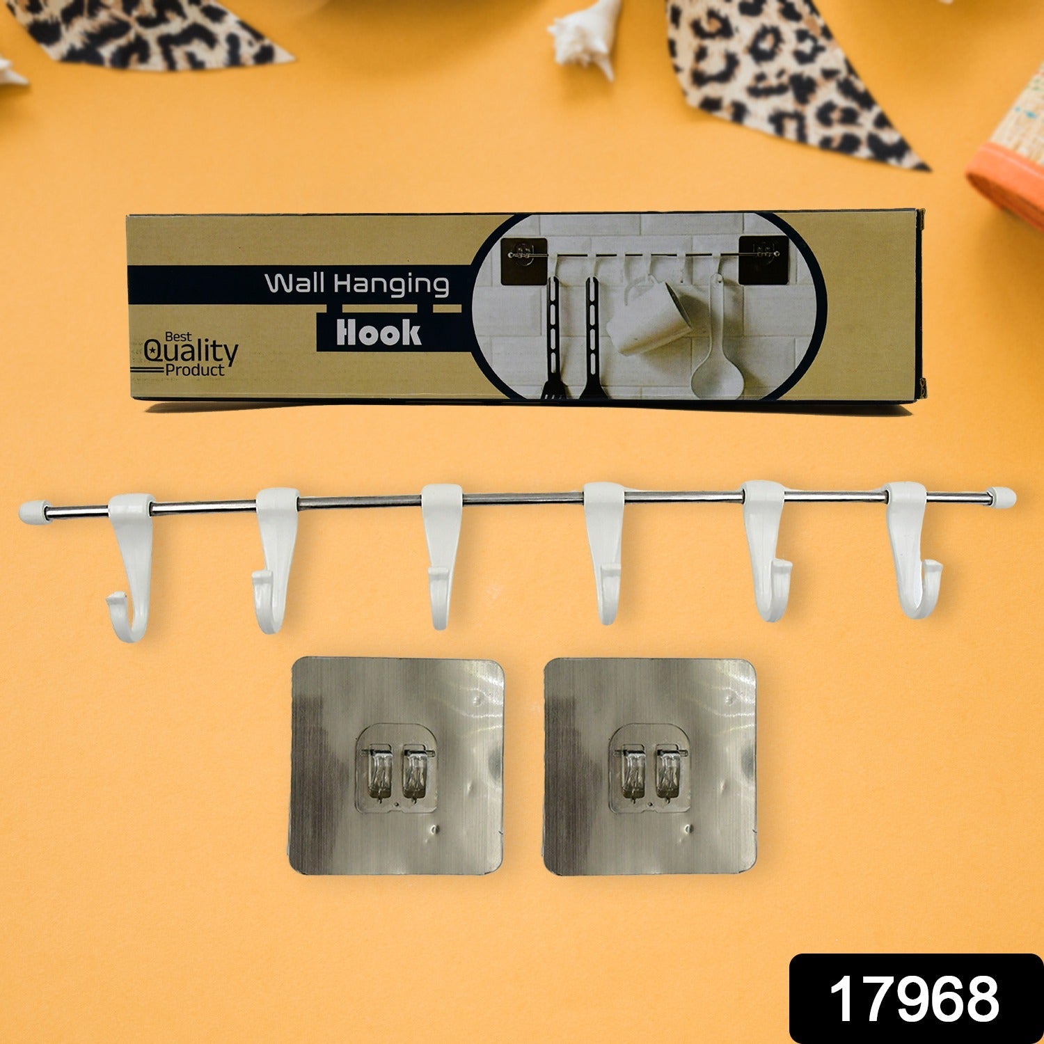 Close-up view of the stainless steel utensil hanger rail, highlighting the plastic hooks and polished finish.