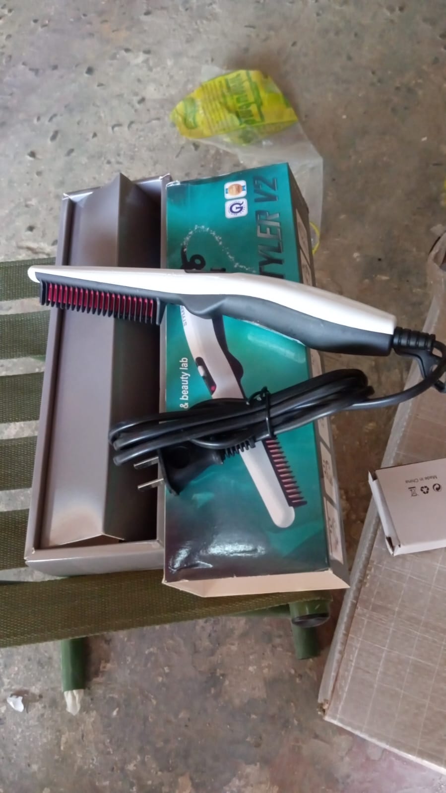 Woman styling her hair with the electric hair straightening comb for a smooth finish.
