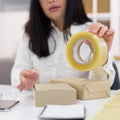 Transparent packing tape roll, high adhesive, for secure sealing.